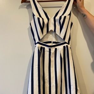 Cute, fashionable, short dress with open space in bellybutton. White under liner